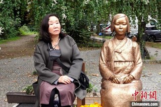 9月16日，在德韩国人协会(Korea Verband)主席韩静和(Nataly Jung-Hwa Han)坐在“慰安妇”雕像旁接受采访。 <a target='_blank'  data-cke-saved-href='http://www.chinanews.com/' href='http://www.chinanews.com/'><ppictext