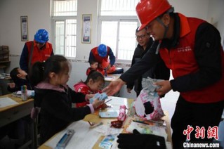 国网供电公司给深村教学点学生捐赠手套等物品。　程暑炜 摄