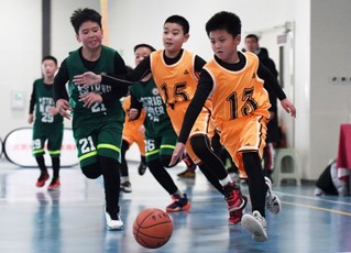 怀柔区第三小学选手在2021年北京市第一届小学生篮球比赛中带球进攻（2021年12月11日摄）。