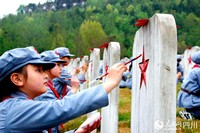红军小学学生为先烈墓碑“描红”。周树江摄