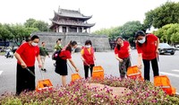 9月3日，江苏扬州仪征市鼓楼广场，志愿者正在捡拾垃圾，美化城市环境