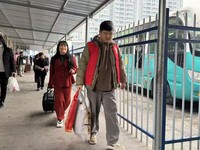 余杰（右一）帮旅客提行李。受访者供图